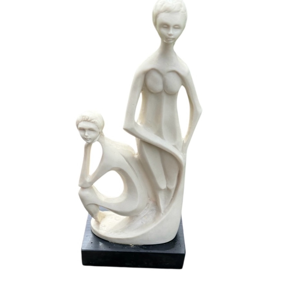 Elegant Cream Sculpture on Black Base made in Italy. Looks to be hand carved